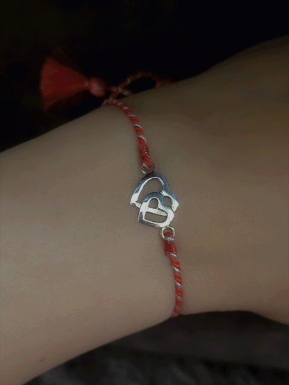 Sterling silver heart on heart pull on red thread rakhi