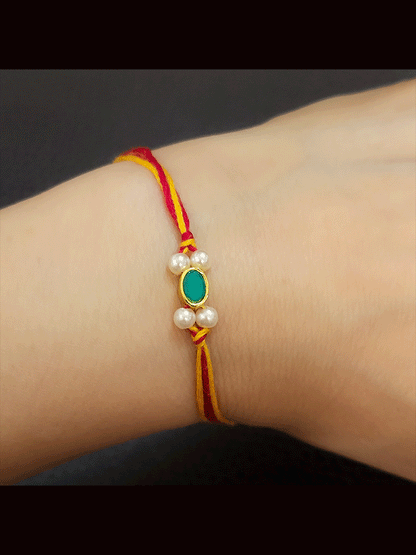 Oval green stone sleek rakhi with white beads on sides