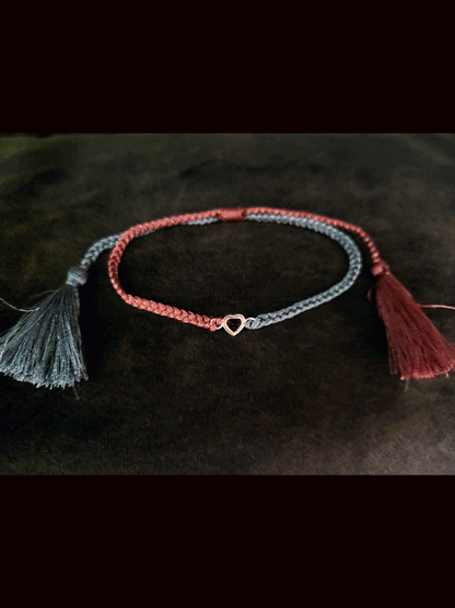 Grey and carrot coloured pull on thread heart shaped red garnet rakhi
