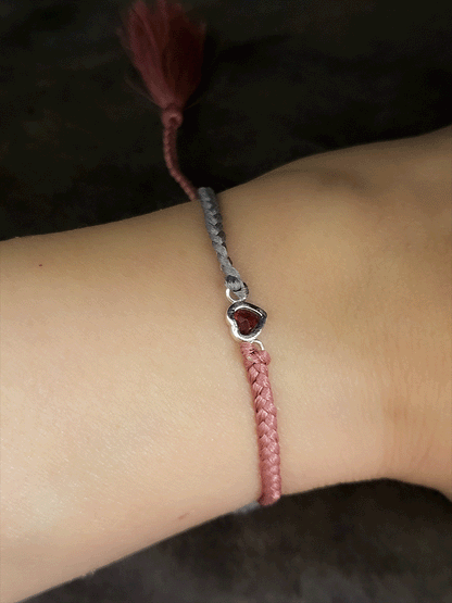Grey and carrot coloured pull on thread heart shaped red garnet rakhi