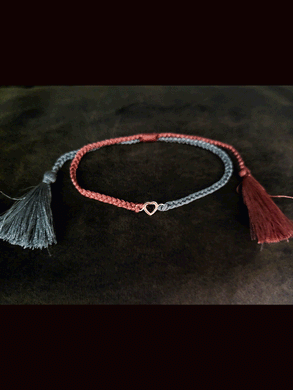 Grey and carrot coloured pull on thread heart shaped red garnet rakhi