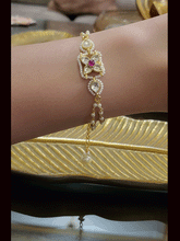 Load image into Gallery viewer, Paachi kundan four leaf flower with ruby stone center bhabhi or sister bracelet rakhi