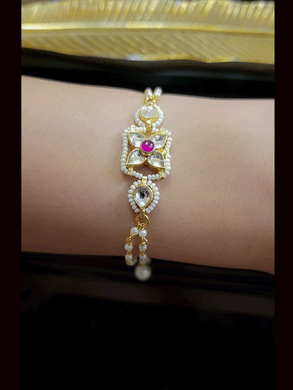 Paachi kundan four leaf flower with ruby stone center bhabhi or sister bracelet rakhi