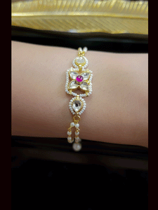Paachi kundan four leaf flower with ruby stone center bhabhi or sister bracelet rakhi
