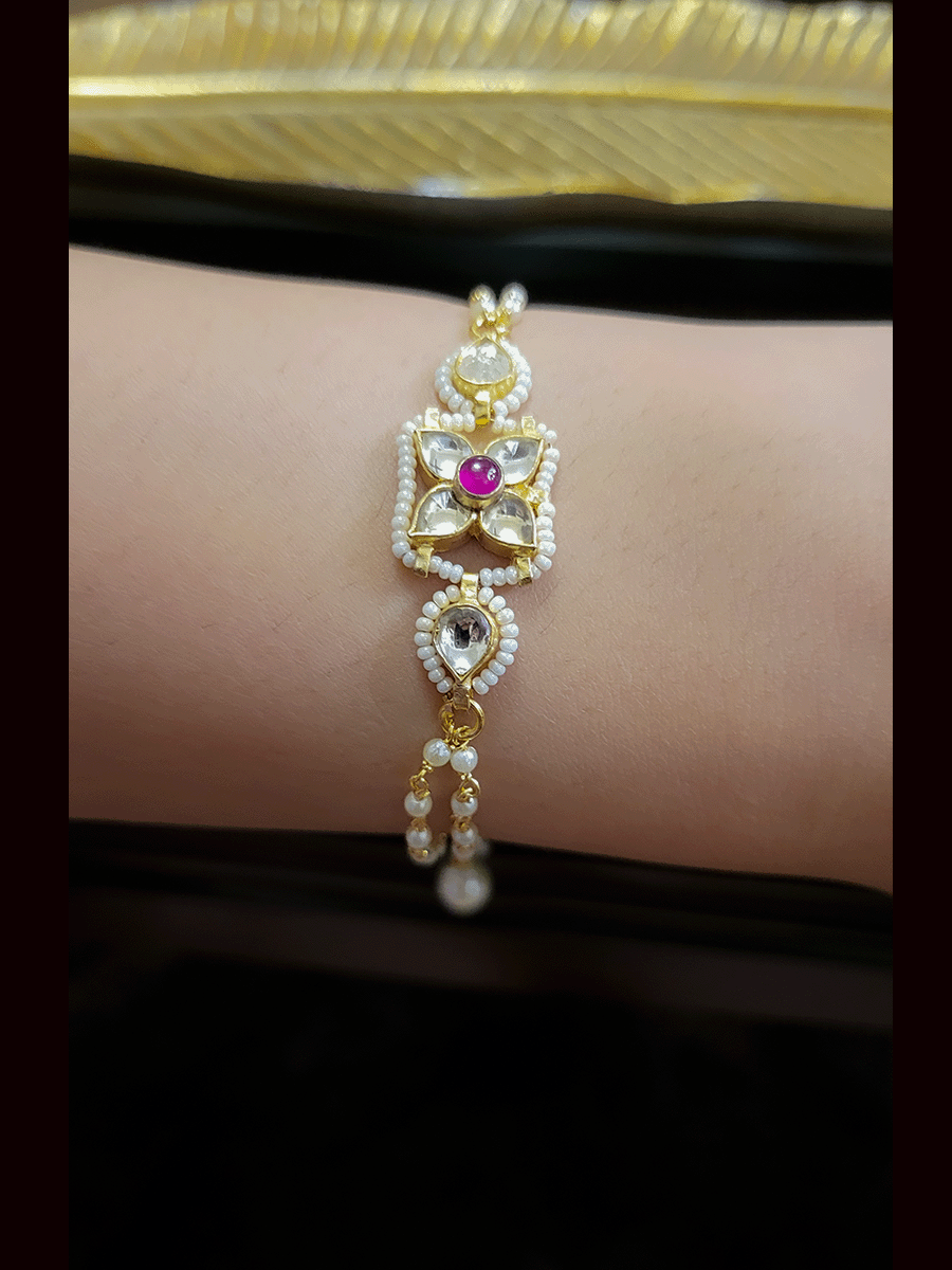 Paachi kundan four leaf flower with ruby stone center bhabhi or sister bracelet rakhi