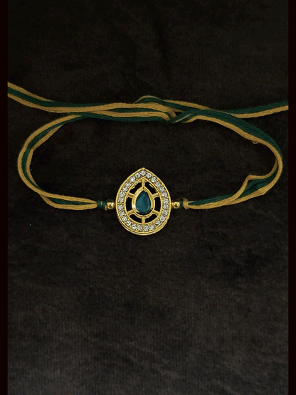 Leaf design AD and green stone bhai rakhi with yellow and green thread