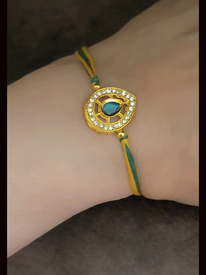Leaf design AD and green stone bhai rakhi with yellow and green thread