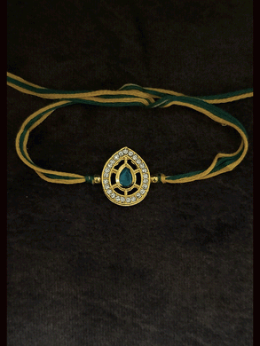 Leaf design AD and green stone bhai rakhi with yellow and green thread