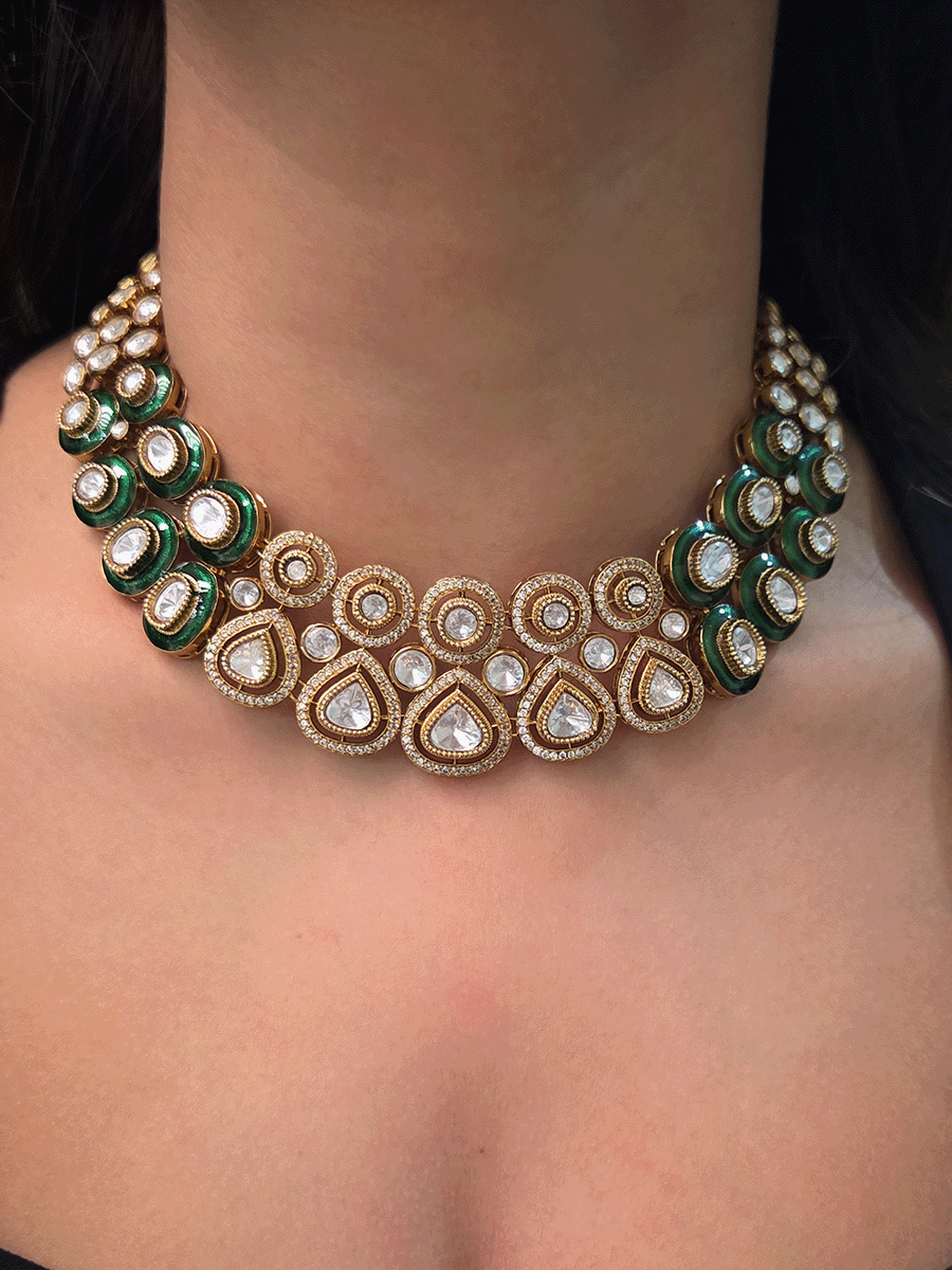 Uncut polki and moissanite studded classy set with green enamel detailing on both sides