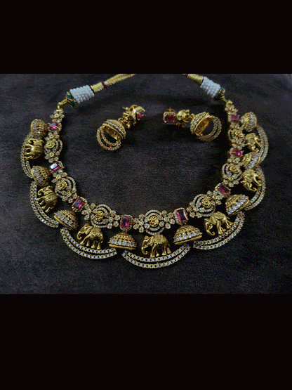 Zircons studded in half jhoomki and elephant design set with rectangular stones