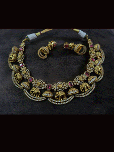 Zircons studded in half jhoomki and elephant design set with rectangular stones