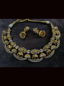 Zircons studded in half jhoomki and elephant design set with rectangular stones