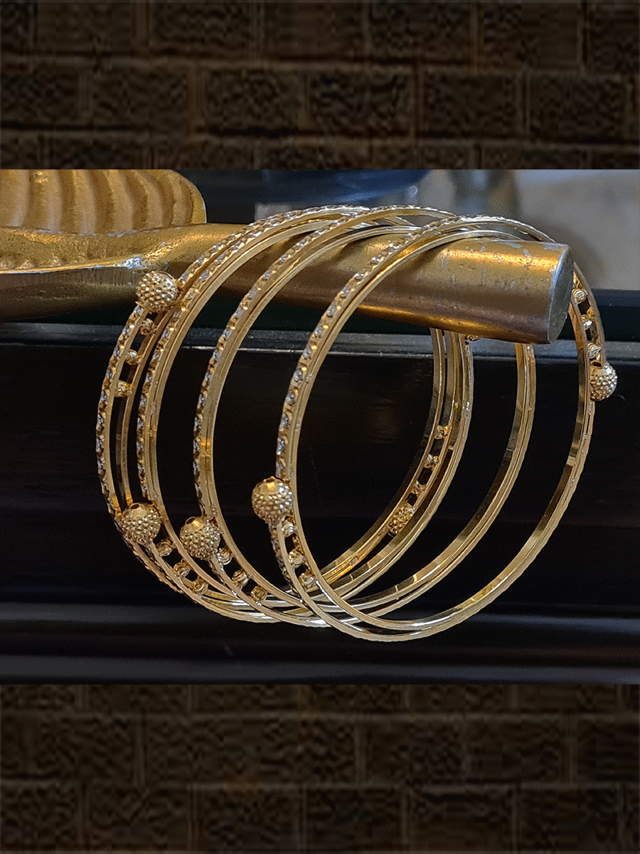 Set of four gold and rhodium plated bangles with self dotted design and gold beads - Odara Jewellery