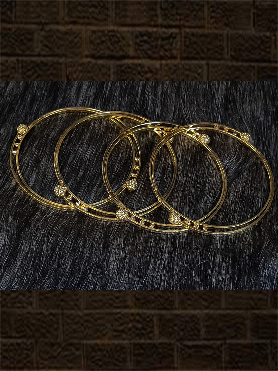 Set of four gold and rhodium plated bangles with self dotted design and gold beads - Odara Jewellery