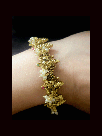 Ganpatiji design openable kada with ruby green stones and bead hangings(set of two)