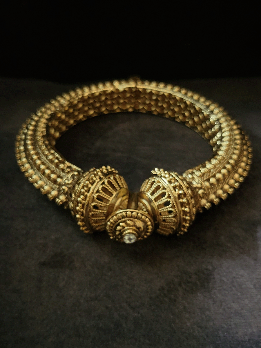 Single openable gold bead and flower design kada with white stone at the top