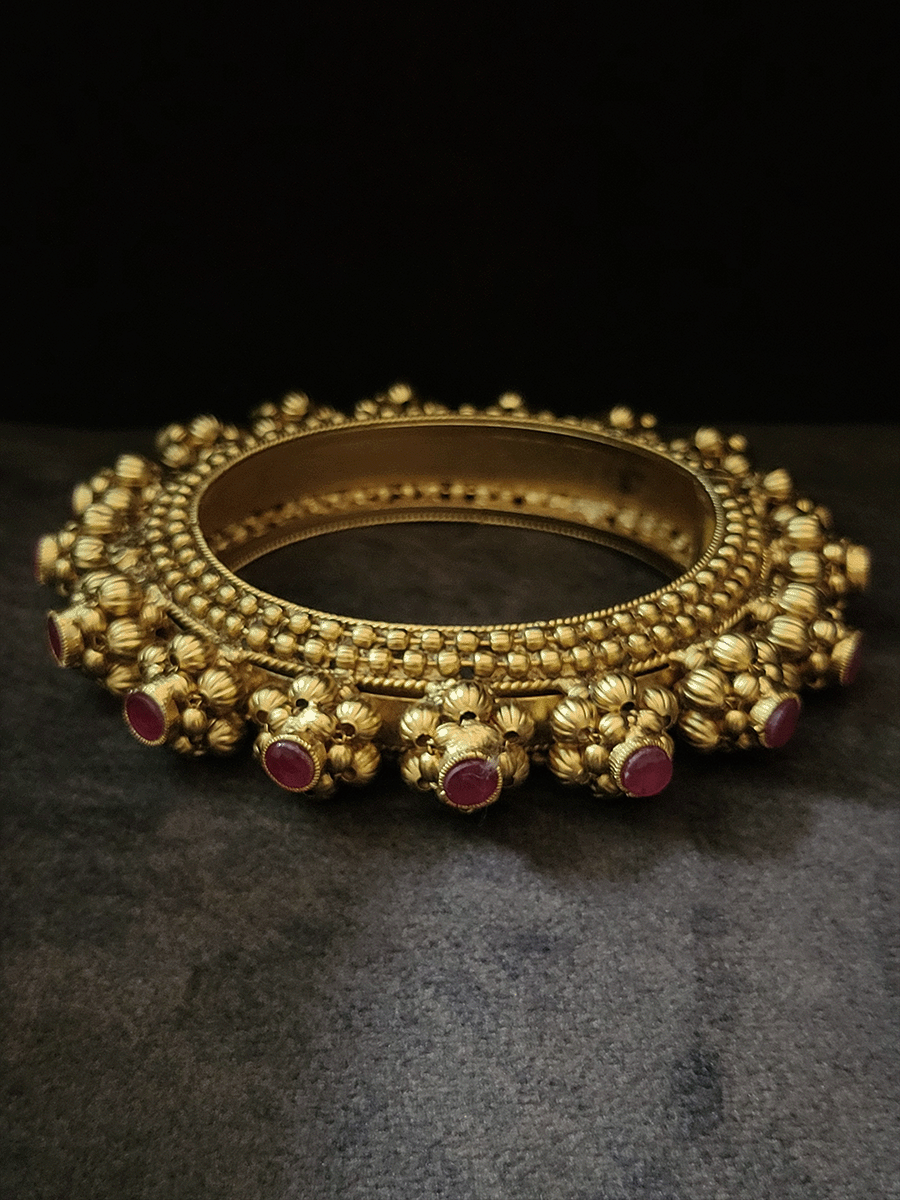 Set of two openable pacheli's with gold bead design and ruby stone top