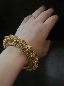 Set of two openable pacheli's with gold bead design and ruby stone top