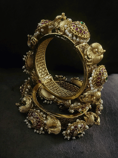 Ruby,polki and green stones pacheli style kadas with elephant design