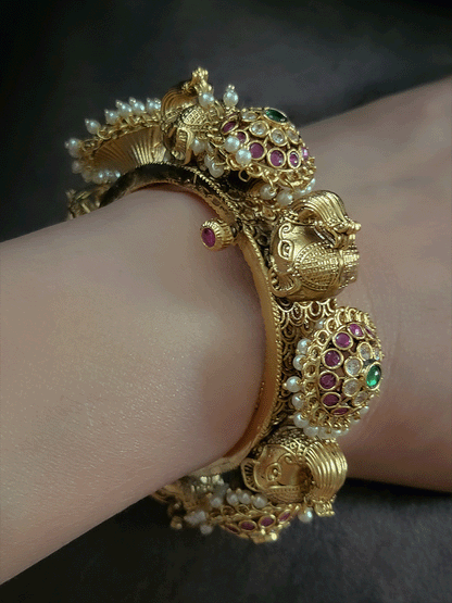 Ruby,polki and green stones pacheli style kadas with elephant design