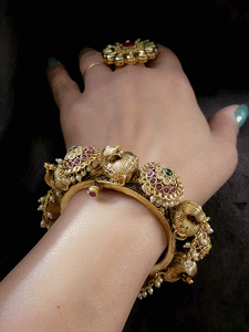 Ruby,polki and green stones pacheli style kadas with elephant design
