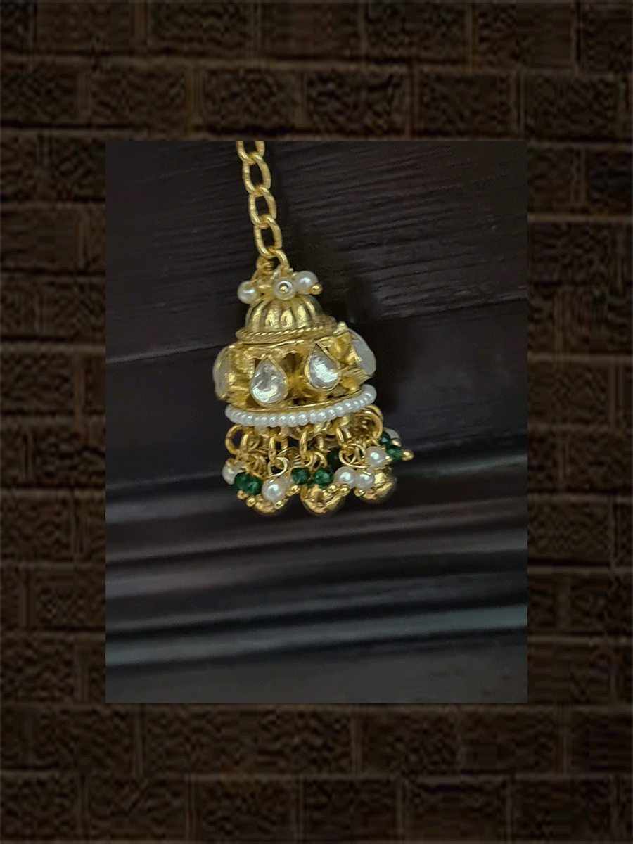 Rectangular kundan tukdi with multiple cheed strings bracelet rakhi with ruby and green bead detailing and hanging kundan jhoomki - Odara Jewellery