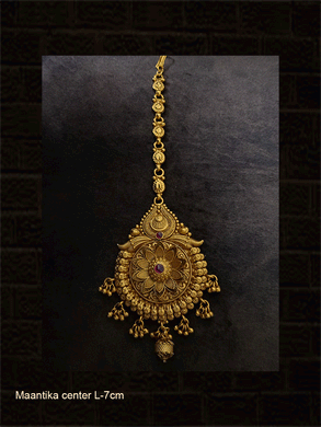 Circular maangtika with center ruby stone bold flower design and leaf design chain