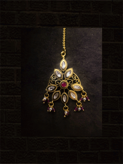Ruby stone center with leaf shaped kundan with chain maangtika