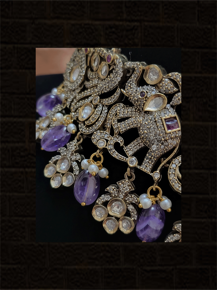 Zircons and kundan studded elephants and peacock design classy set with green and ruby stones