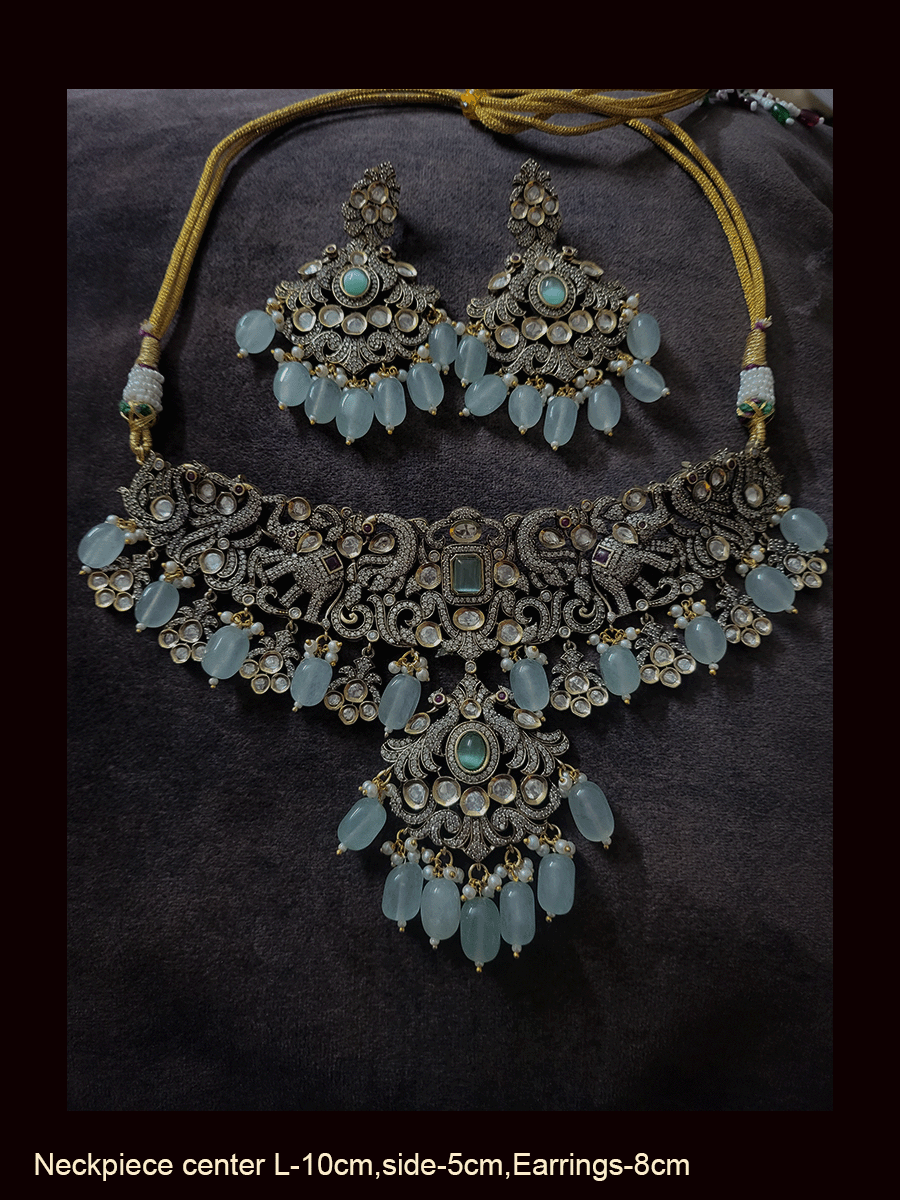 Zircons and kundan studded elephants and peacock design classy set with green and ruby stones