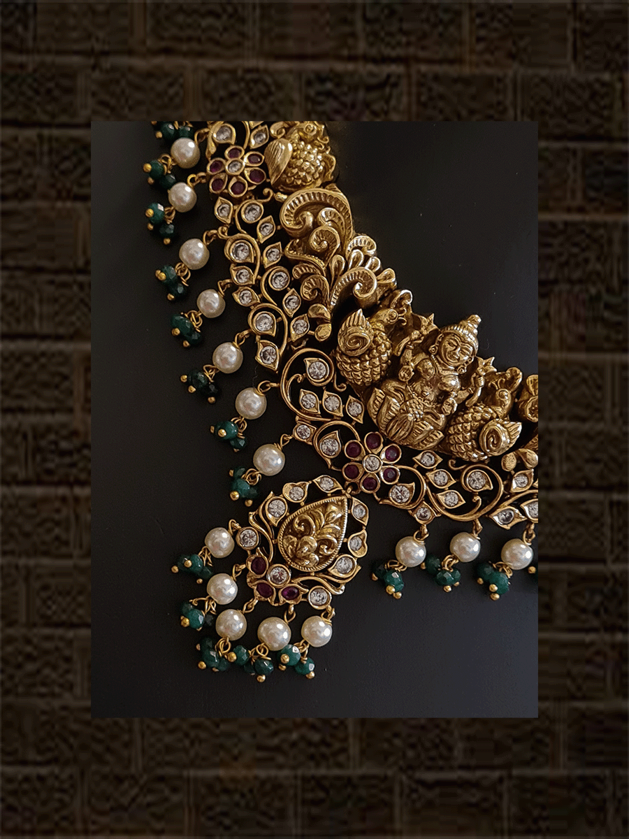 Intricate design polki ,ruby and green stones studded laxmiji set with pearl and green bead drops - Odara Jewellery