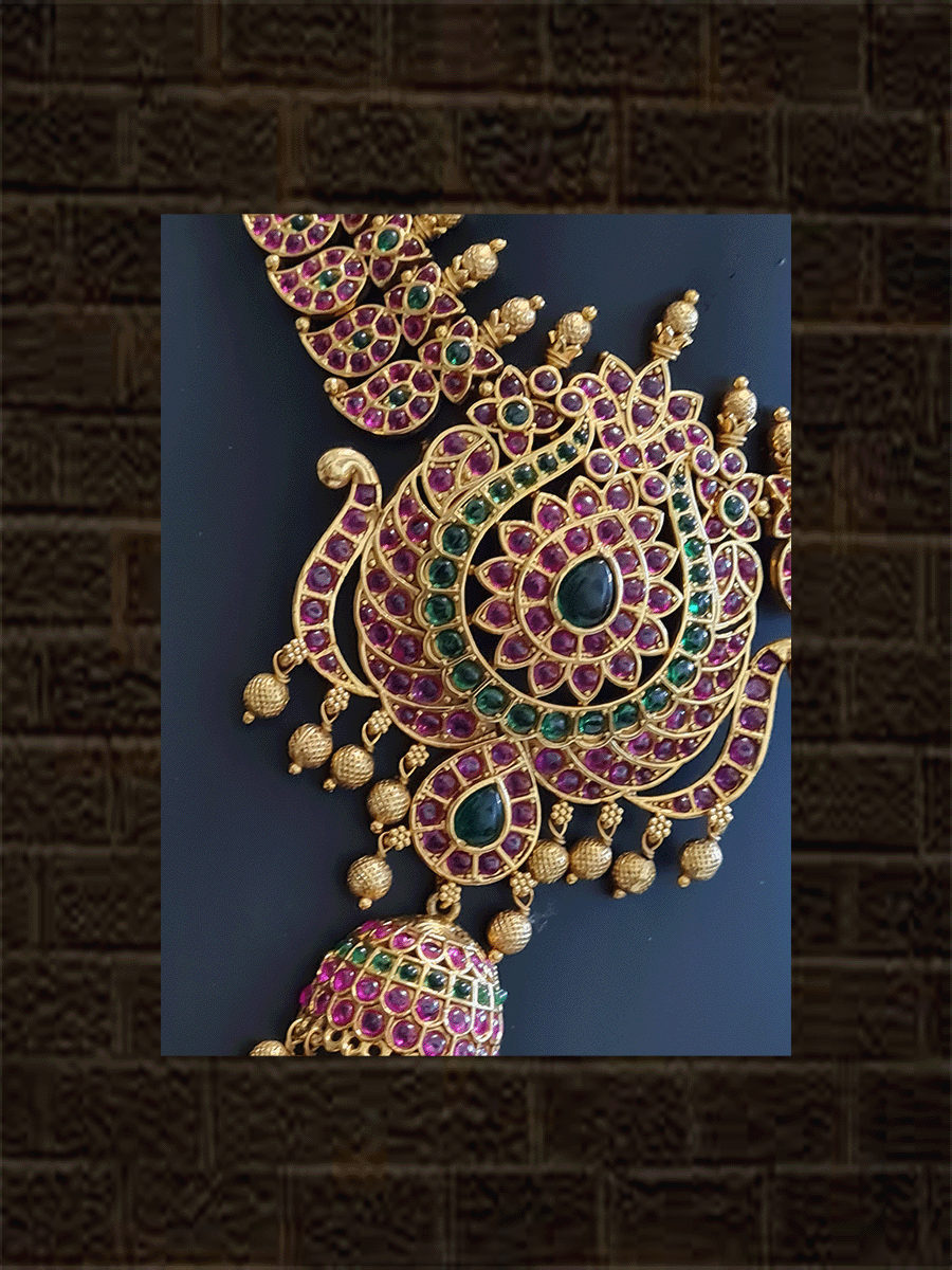 Paisley design side string with ruby and green stones studded pendant with leaf shaped green stones in center - Odara Jewellery