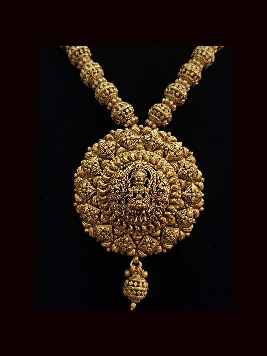 Intricate design laxmiji motif pendant set in matar bead string with jhoomkies