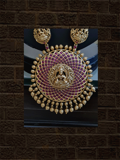 Round ruby stone studded laxmiji motif pendant long set with flower and laxmiji design side chain - Odara Jewellery