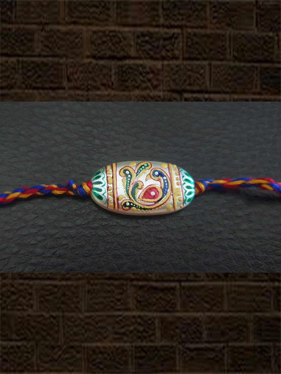 Hand painted peacock design white oval bead rakhi(approx.1inches bead) - Odara Jewellery