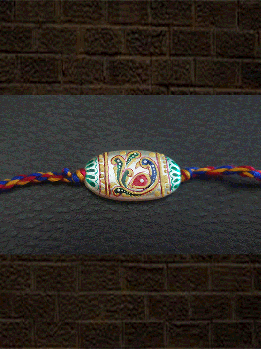 Hand painted peacock design white oval bead rakhi(approx.1inches bead) - Odara Jewellery