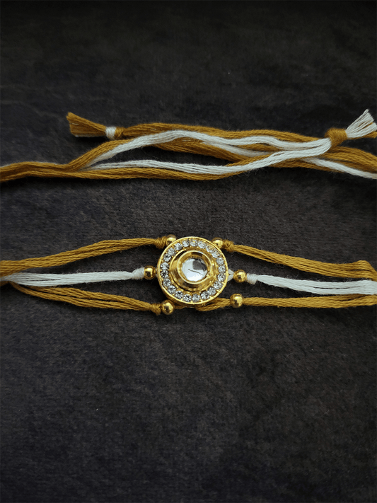 Circular kundan and AD rakhi with brown and white thread - Odara Jewellery