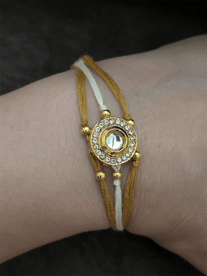 Circular kundan and AD rakhi with brown and white thread - Odara Jewellery