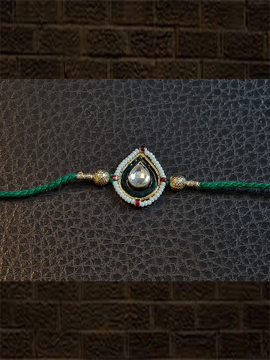 Green enamel leaf design rakhi with pirohi in green thread - Odara Jewellery