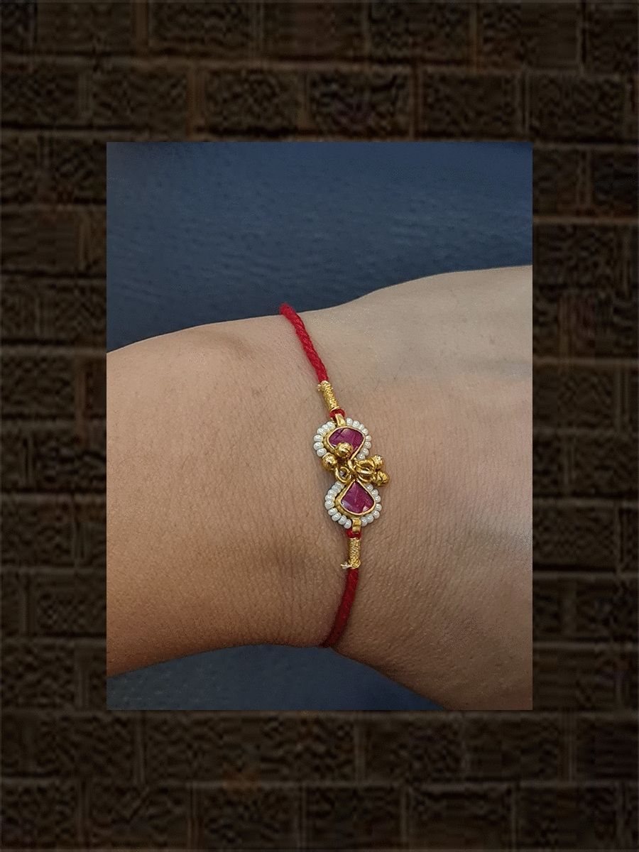 Ruby triangular stones with ghunghru and pirohi work red thread rakhi - Odara Jewellery