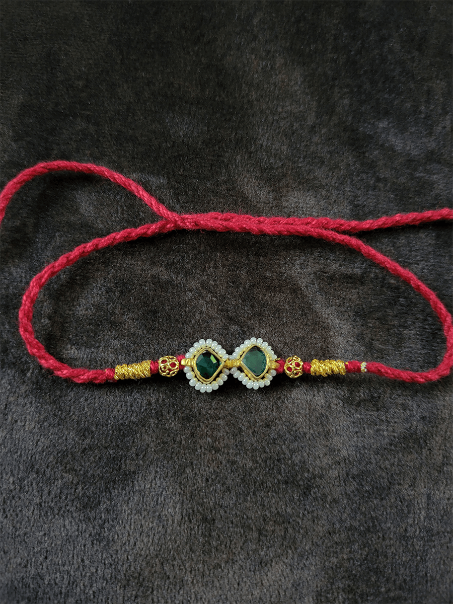 Pacchi kundan with pirohi rakhi in red thread - Odara Jewellery