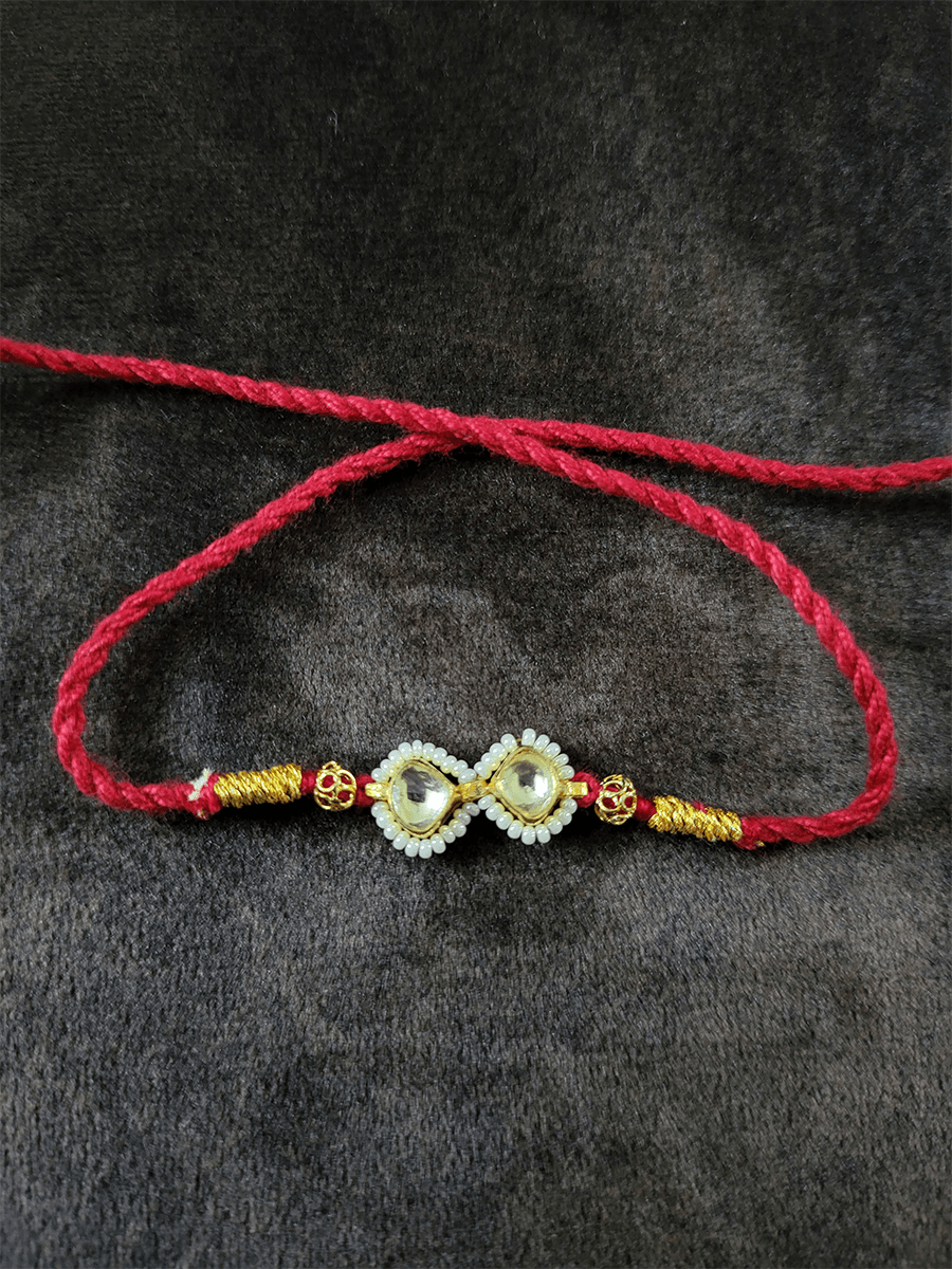 Pacchi kundan with pirohi rakhi in red thread - Odara Jewellery