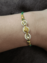 Load image into Gallery viewer, Two kundan leaf with pirohi work and antique tukdi rakhi in green thread - Odara Jewellery