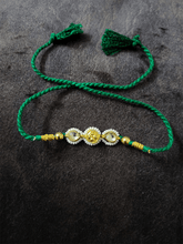 Load image into Gallery viewer, Two kundan leaf with pirohi work and antique tukdi rakhi in green thread - Odara Jewellery