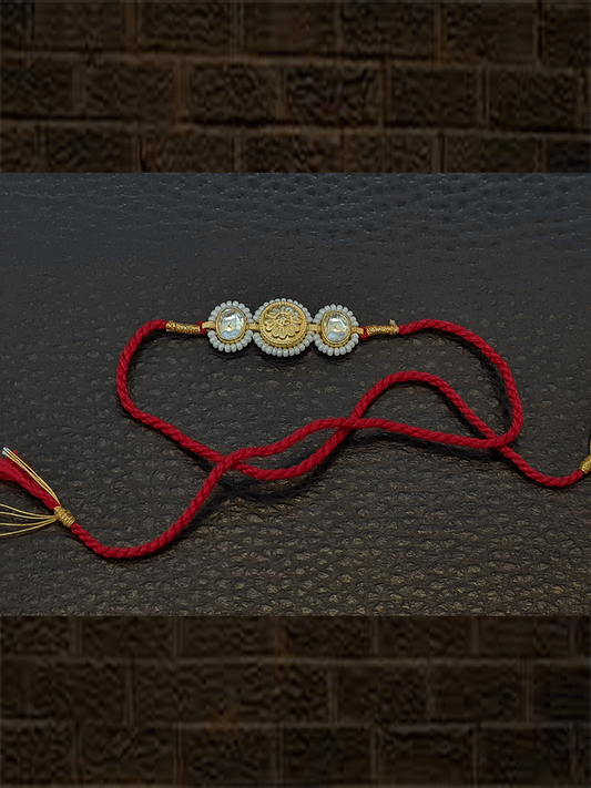 Kundan on sides of antique tukdi pirohi work red thread rakhi - Odara Jewellery