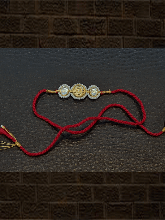 Kundan on sides of antique tukdi pirohi work red thread rakhi - Odara Jewellery