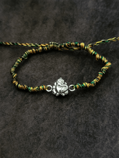 Sterling silver ganpati ji rakhi in multicoloured adjustable thread - Odara Jewellery