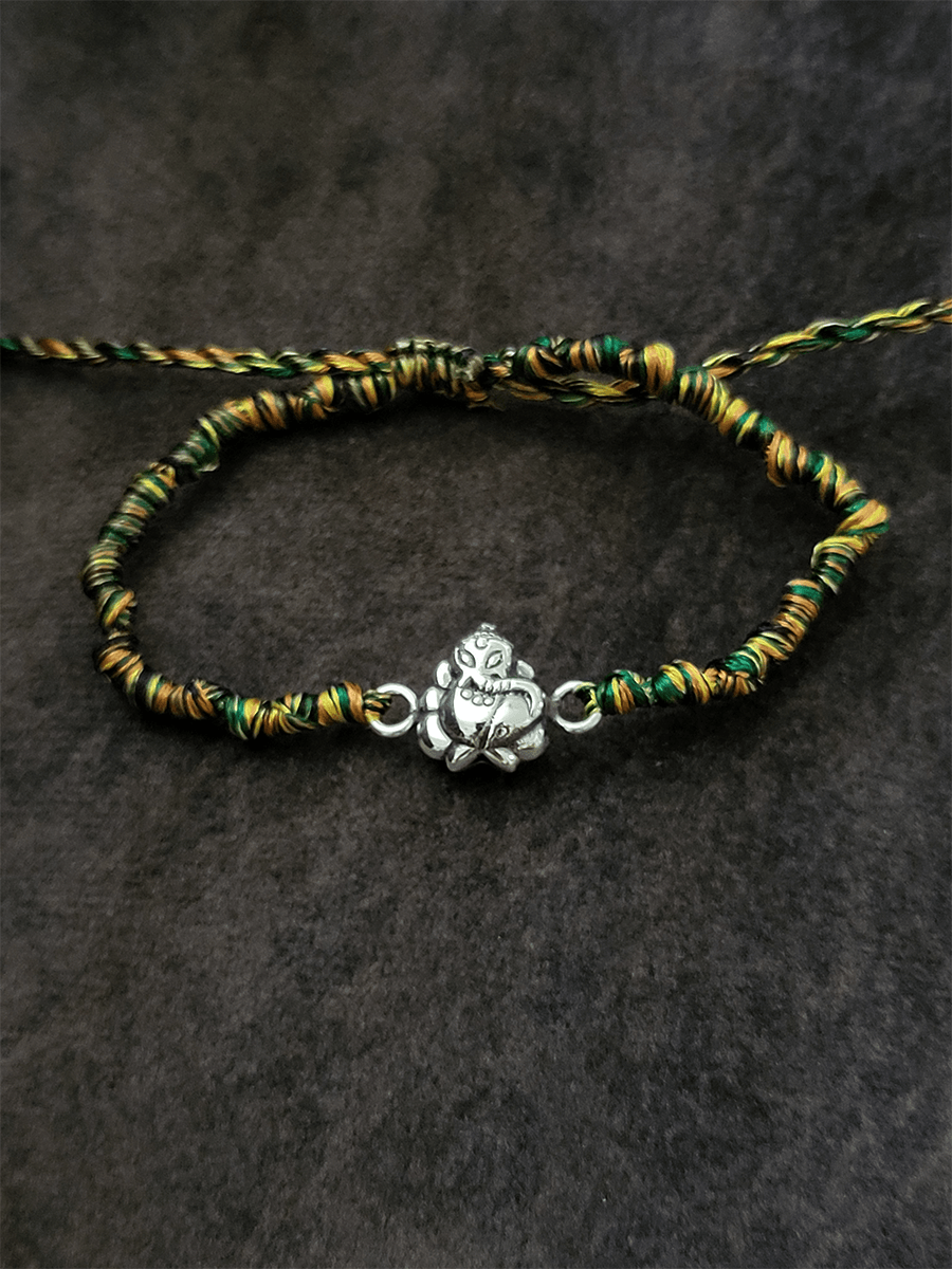 Sterling silver ganpati ji rakhi in multicoloured adjustable thread - Odara Jewellery
