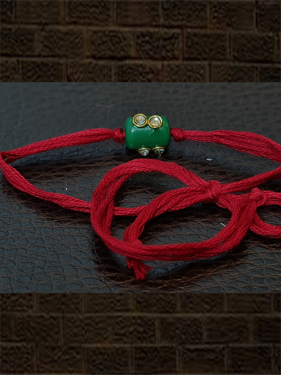 Green bead red thread kundan rakhi - Odara Jewellery