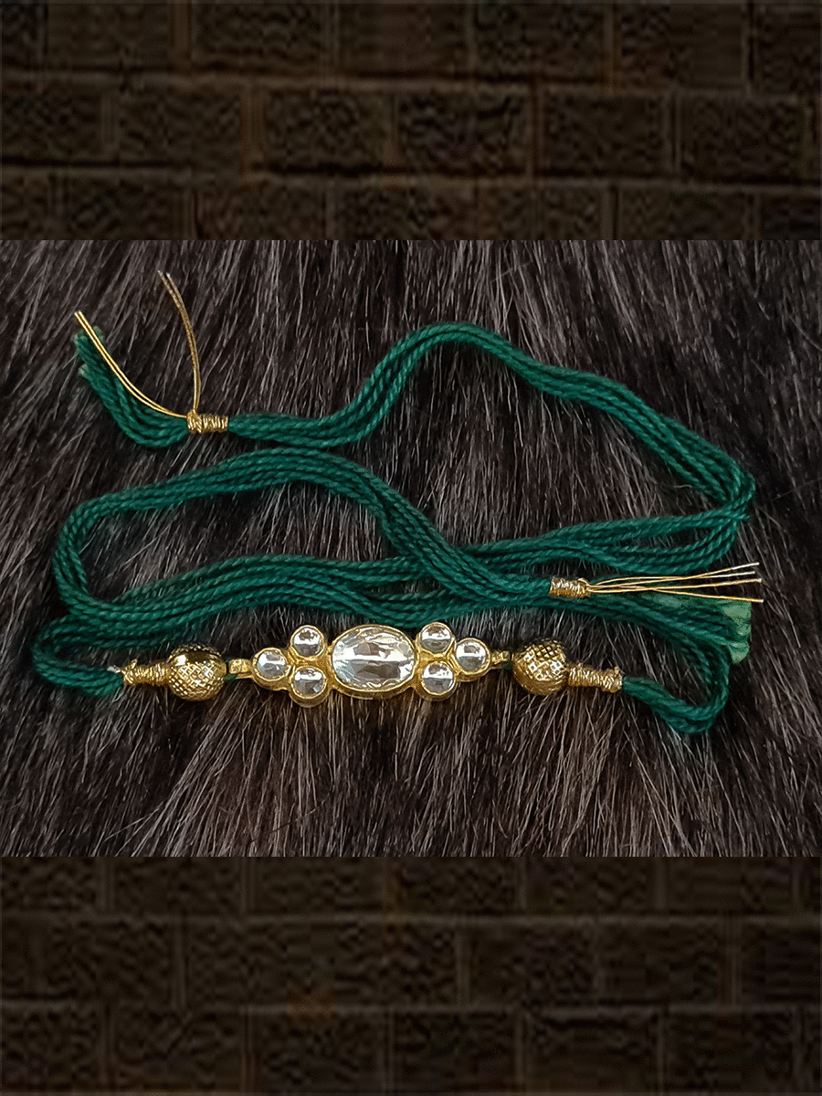 Elegant kundan rakhi in red and green thread with side gold beads - Odara Jewellery